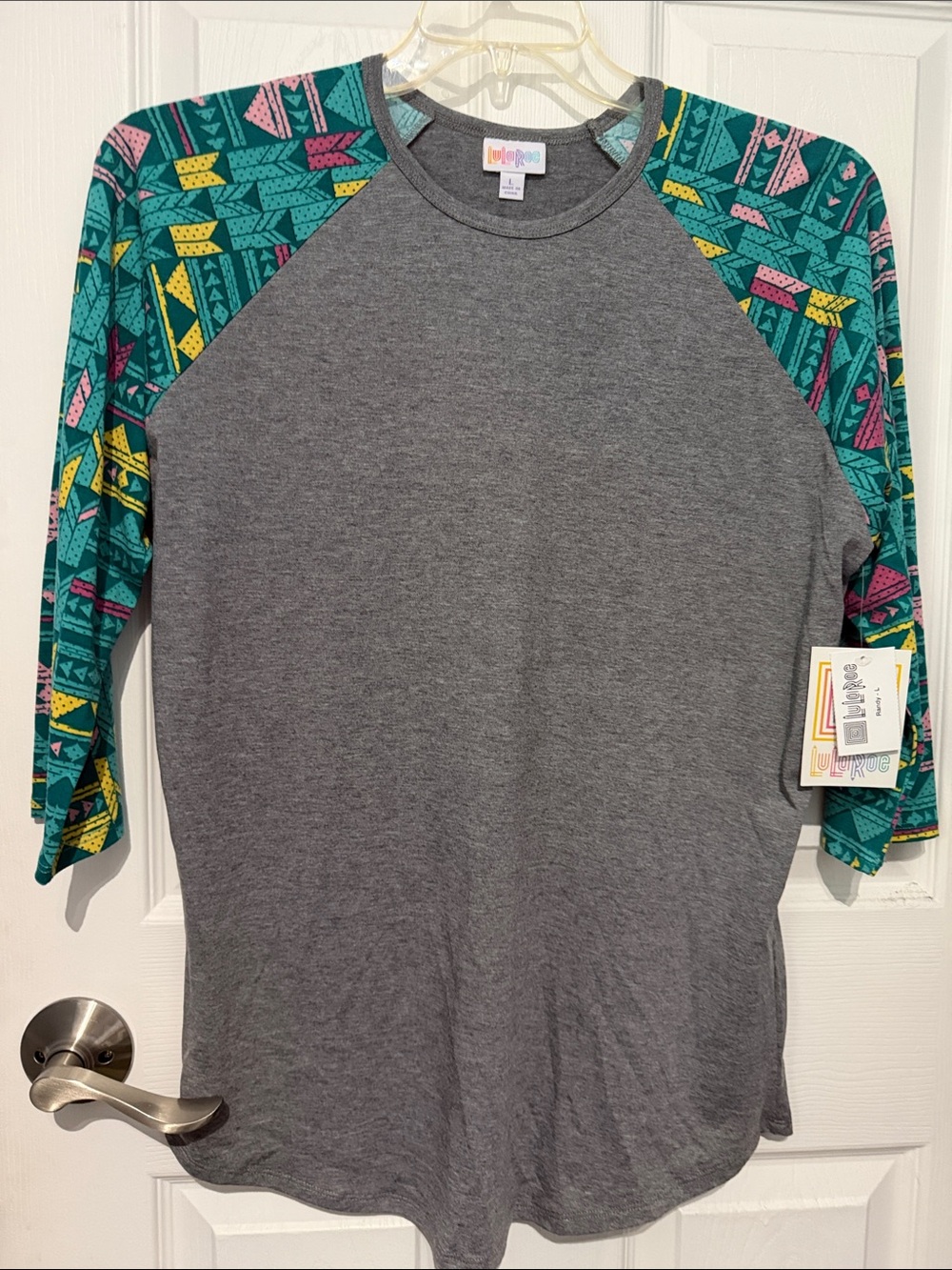 NWT LuLaRoe Women’s Gray Raglan Top with Teal Patterned Sleeves. Size large.